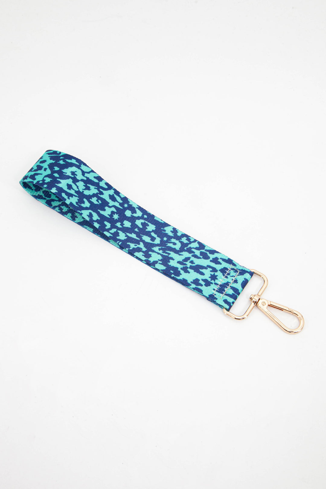 aqua blue and navy blue leopard print wristlet bag strap with a subtle scattered star pattern throughout the design