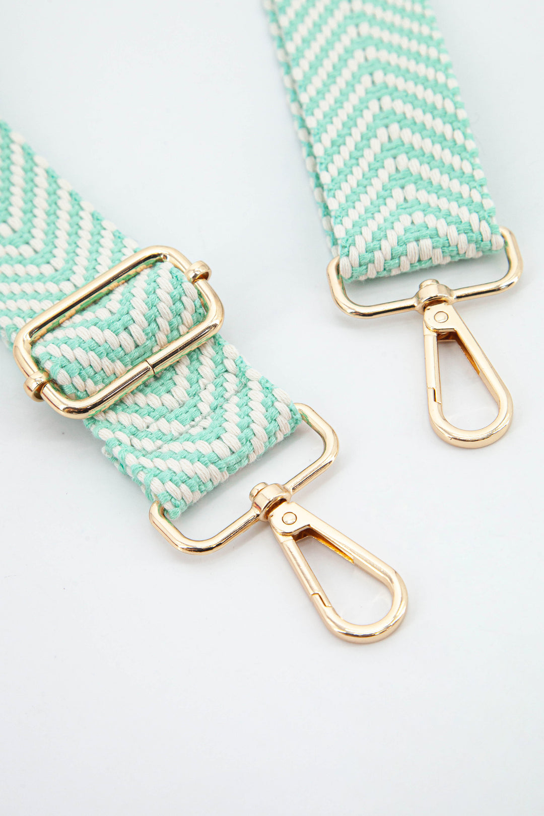 close up of the gold clip on snap hook attachments and the mint green chevron pattern