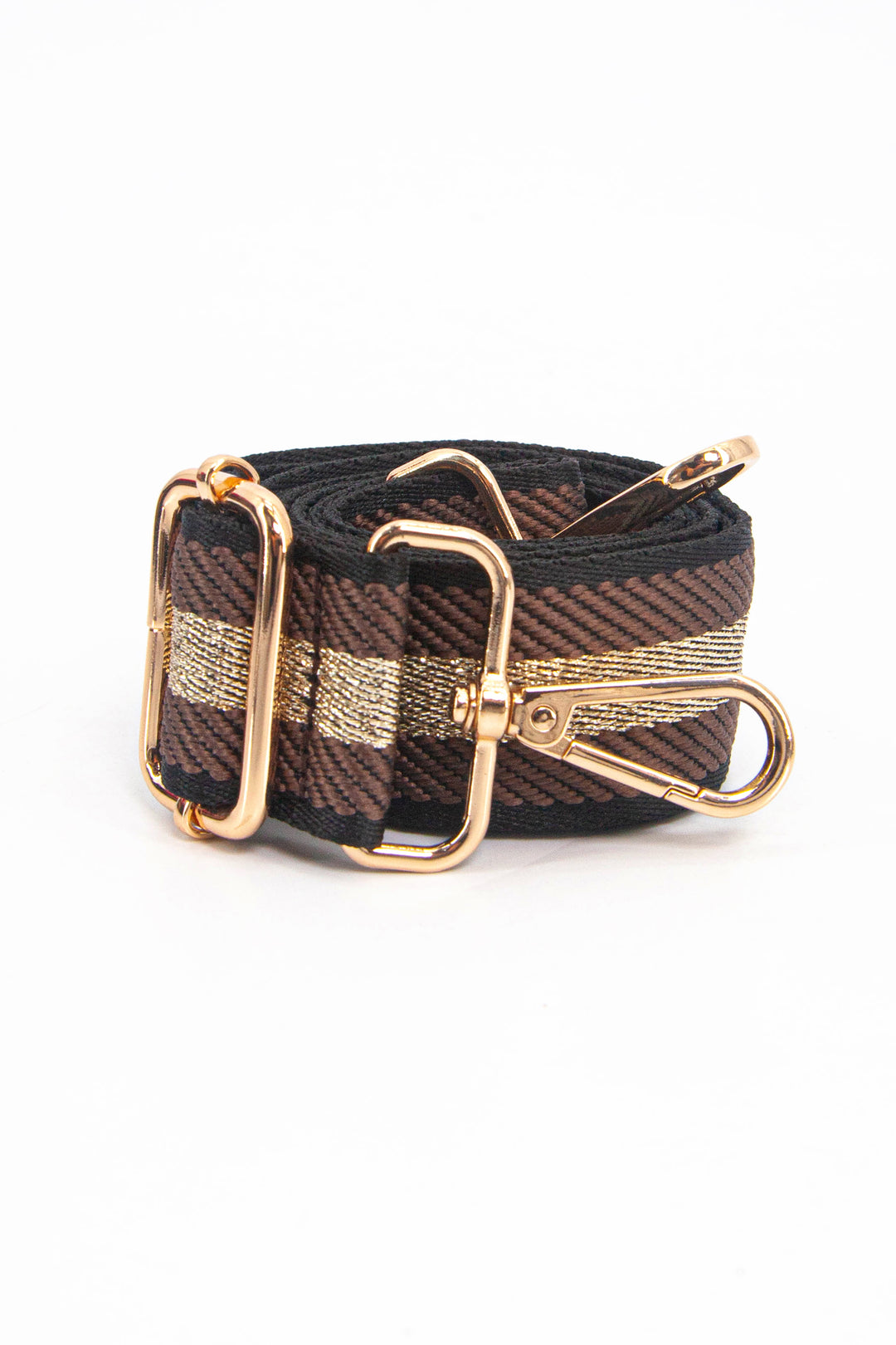 showing the bag strap coiled around itself, the tan and gold metallic striped woven design is prominent , the gold hardware is shown in close up