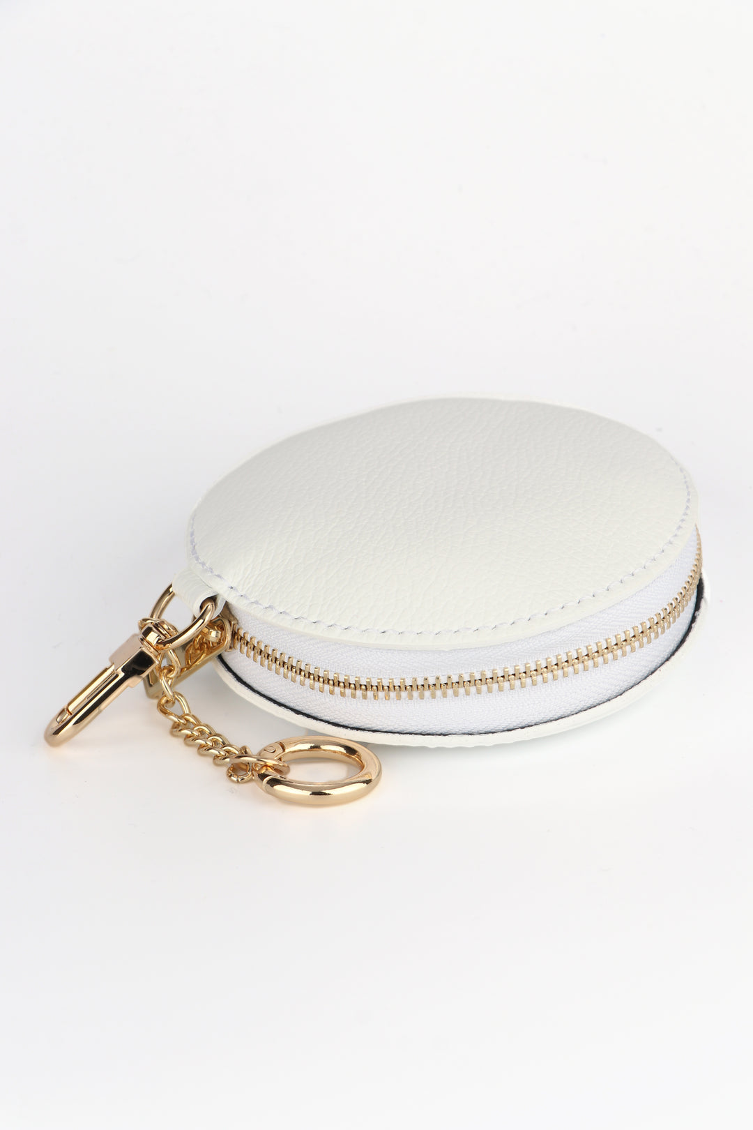 white leather round coin purse with a gold zip closure 