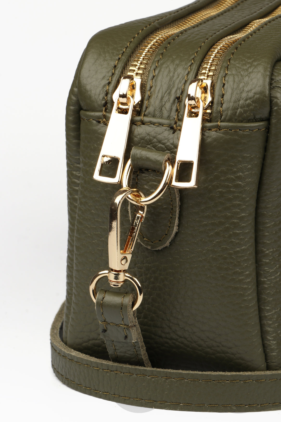 close up of the gold zip closure on the khaki green leather bag