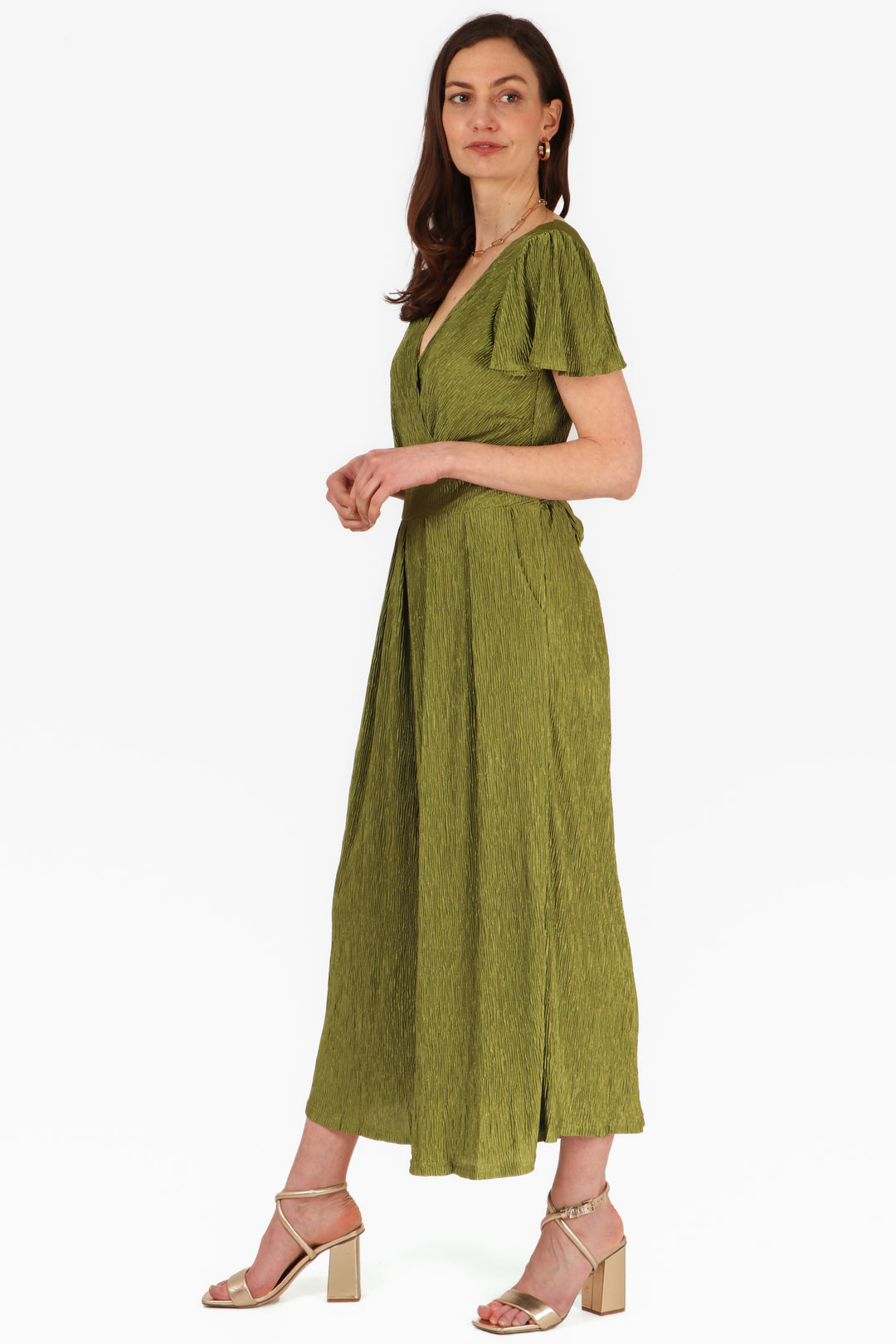 model wearing an olive green plisse fabric jumpsuit with v neck and short angel sleeves