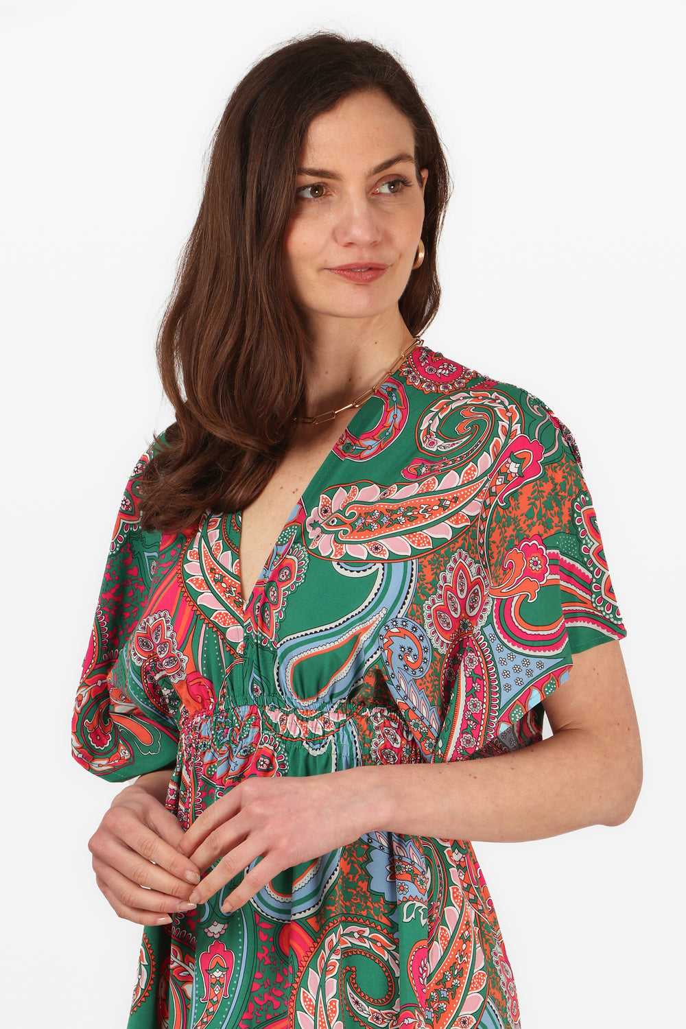 close up of the plunging v neck and green and pink paisley print pattrern, this dress has a shirred elasticated waistband