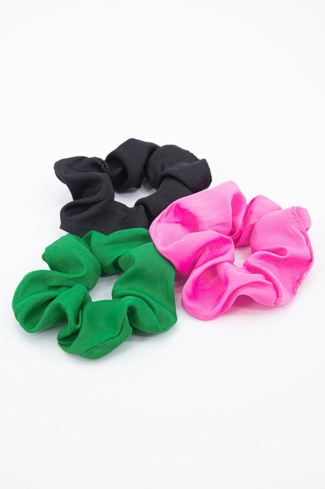 showing all three plain scrunchies in our collection, green, black and pink