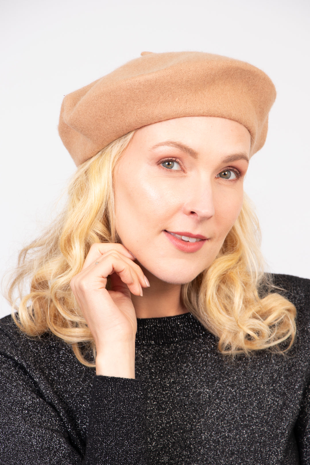 model wearing a neutral beige camel wool beret