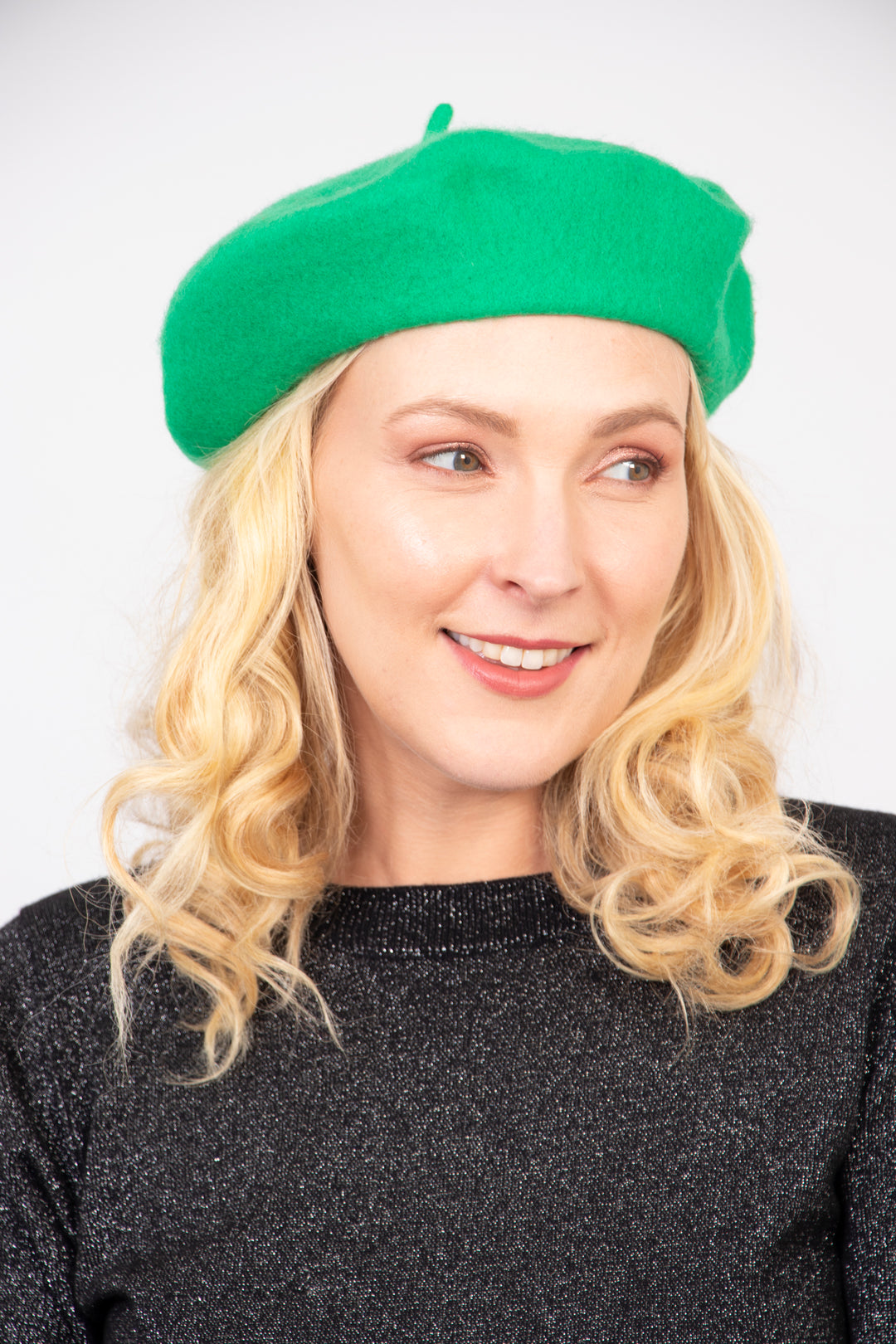 model wearing a bright green plain beret hat