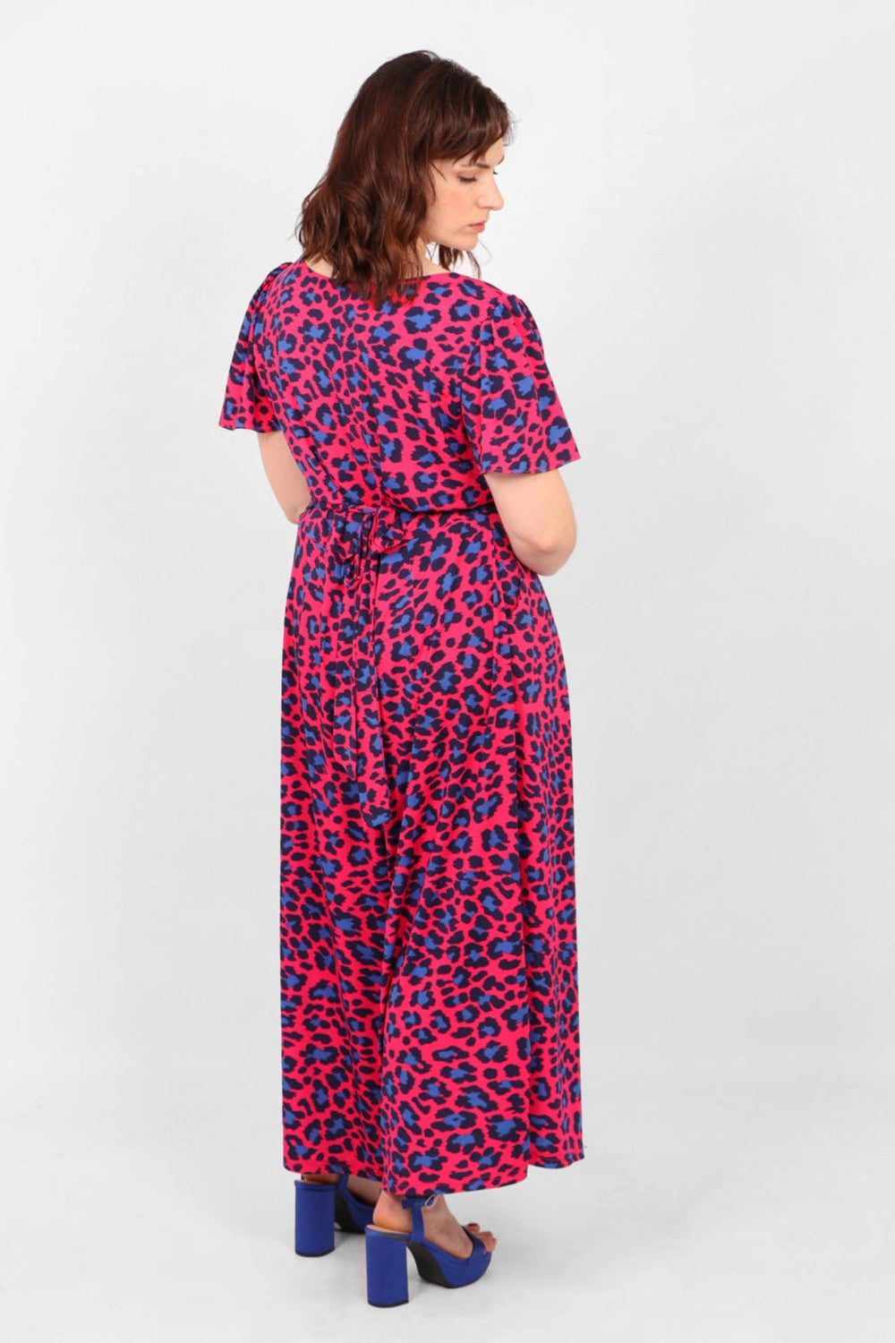 Model showing back of fuchsia and blue leopard print jumpsuit