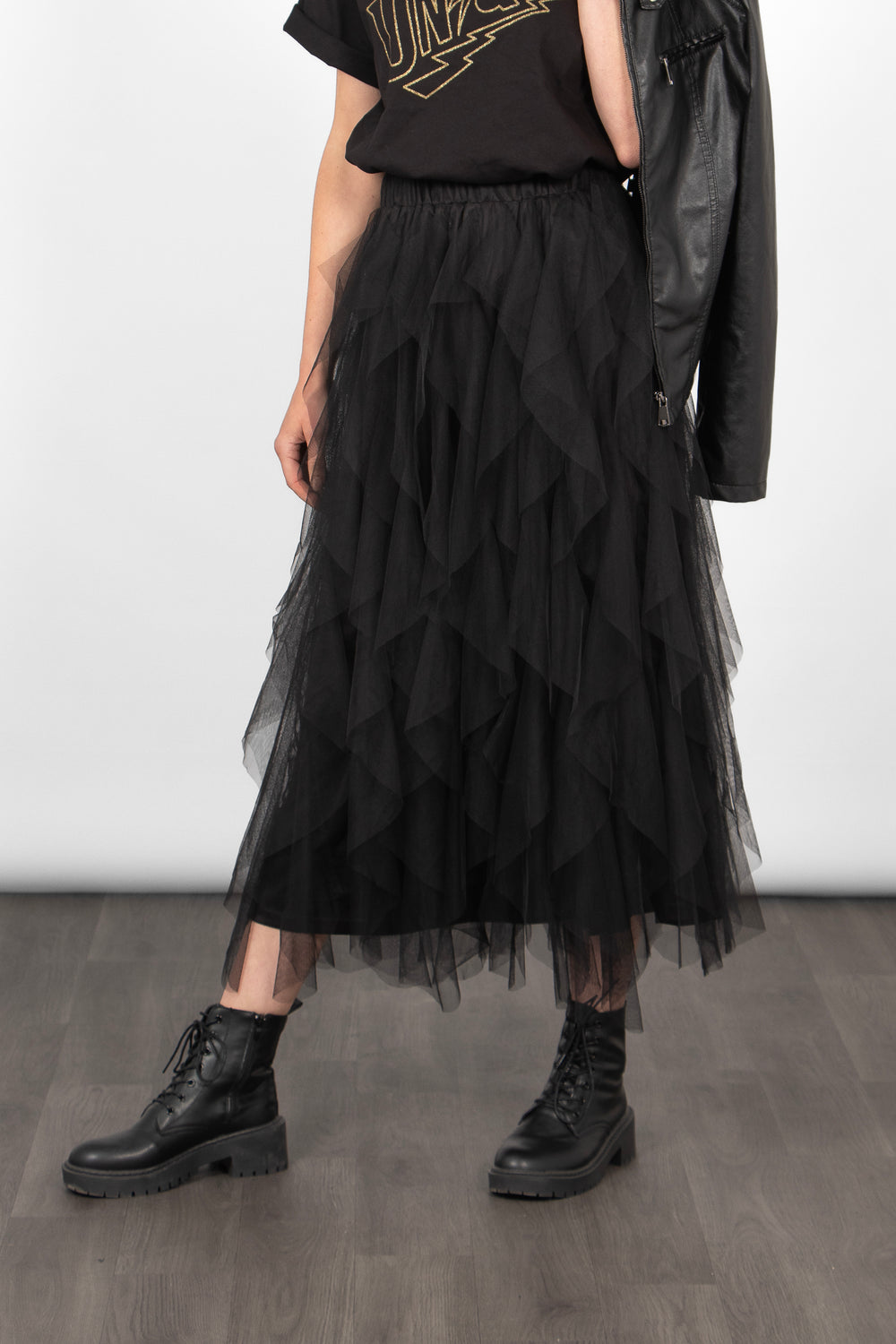close up of model wearing a black gathered tulle midi skirt with an elasticated waistband