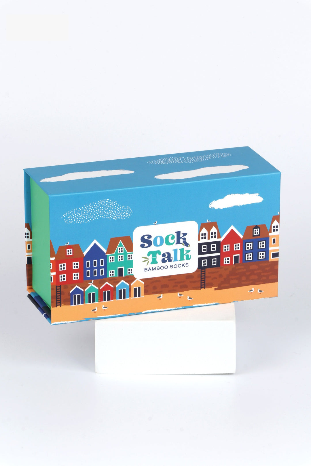 a sock gift box which fits three pairs of bamboo socks artistically designed to look like a seaside village scene with beach and colourful beach huts