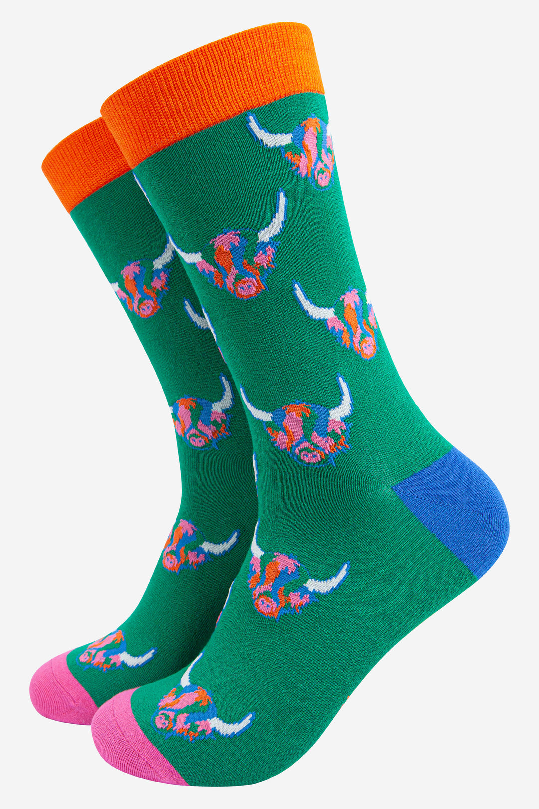 green socks with a pattern of rainbow highland cows