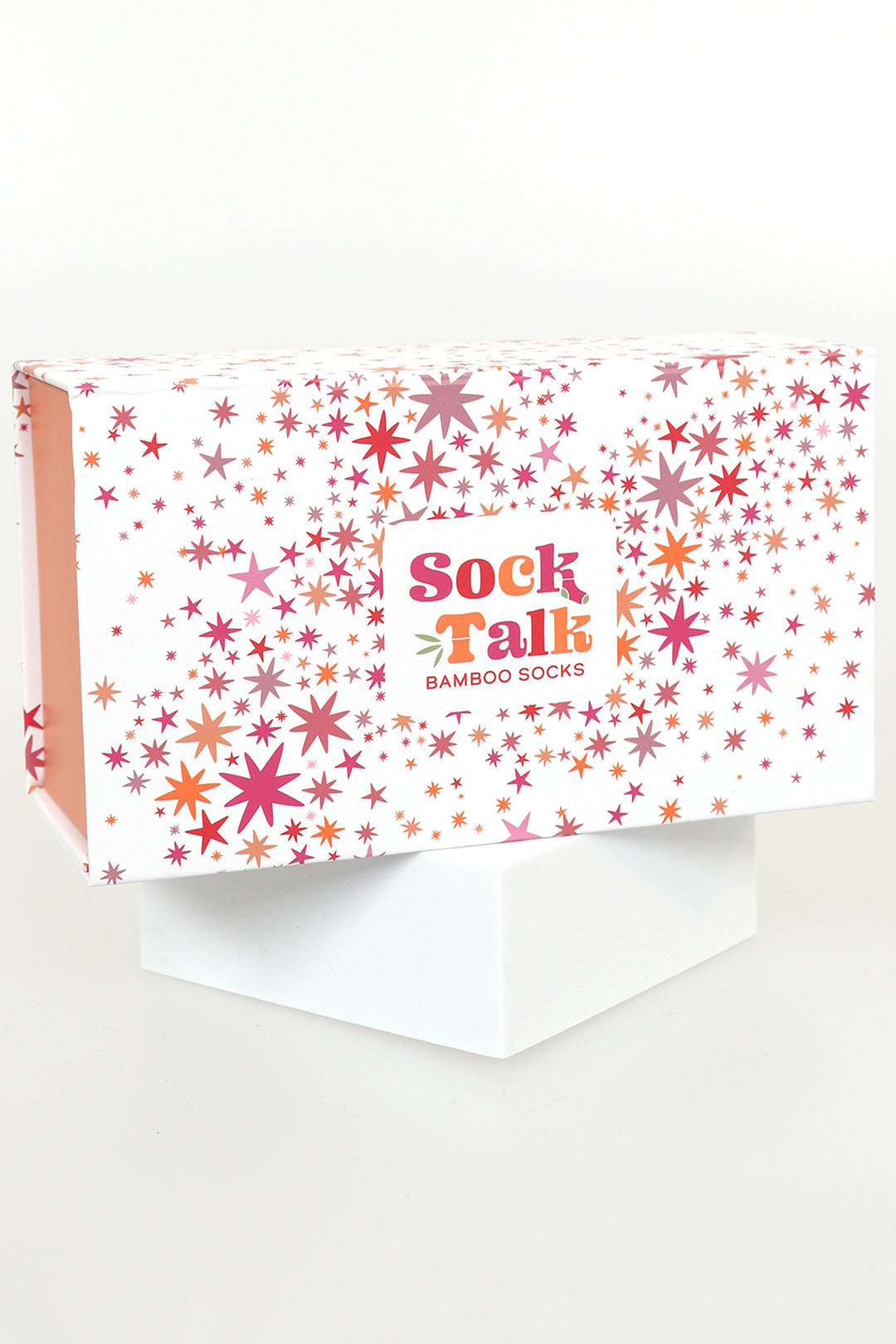 white gift box with an all over scattered pink star print pattern