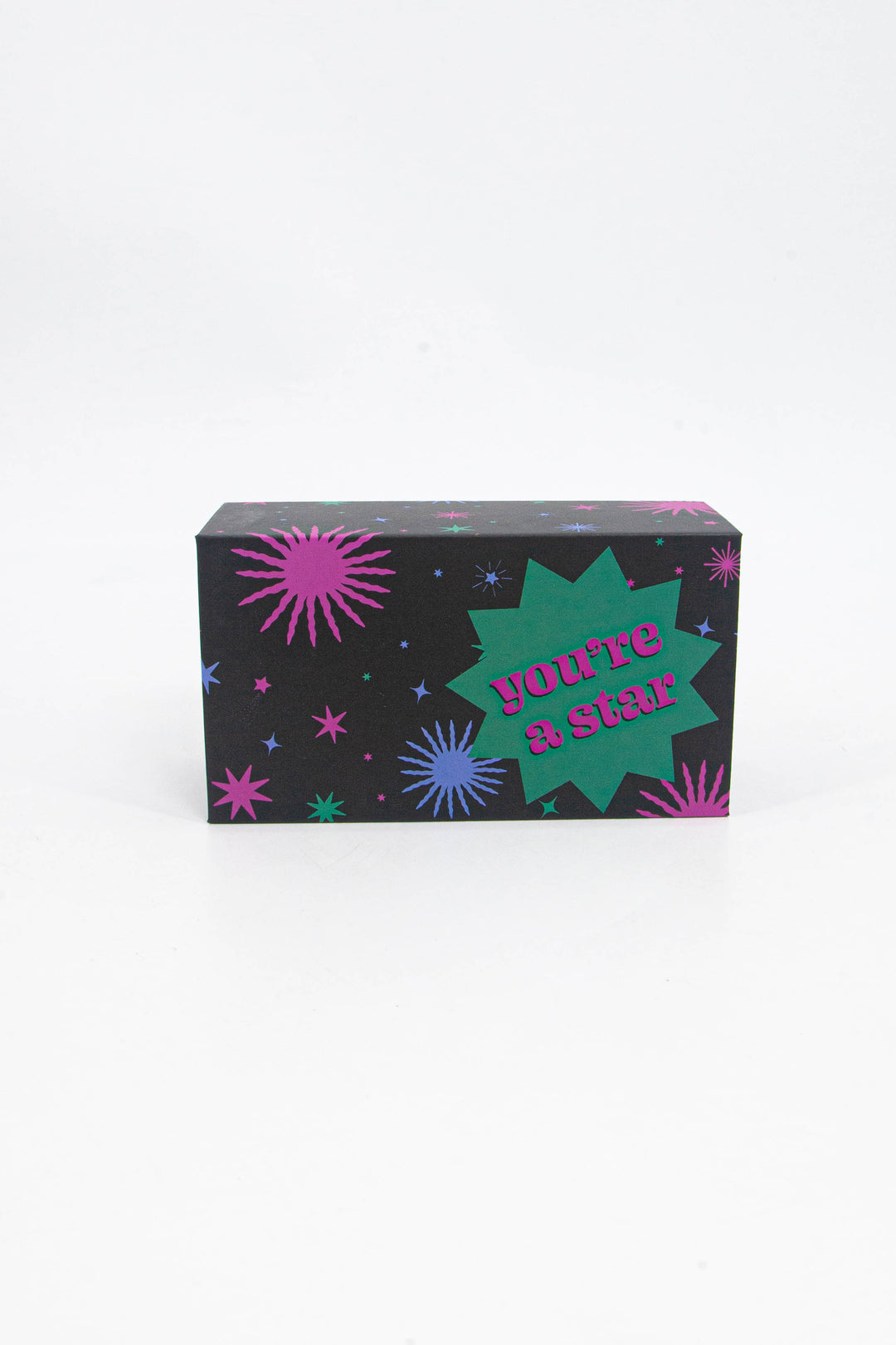 black gift box with a green, blue and pink star burst pattern with the words "you're a star" boldly printed on the front