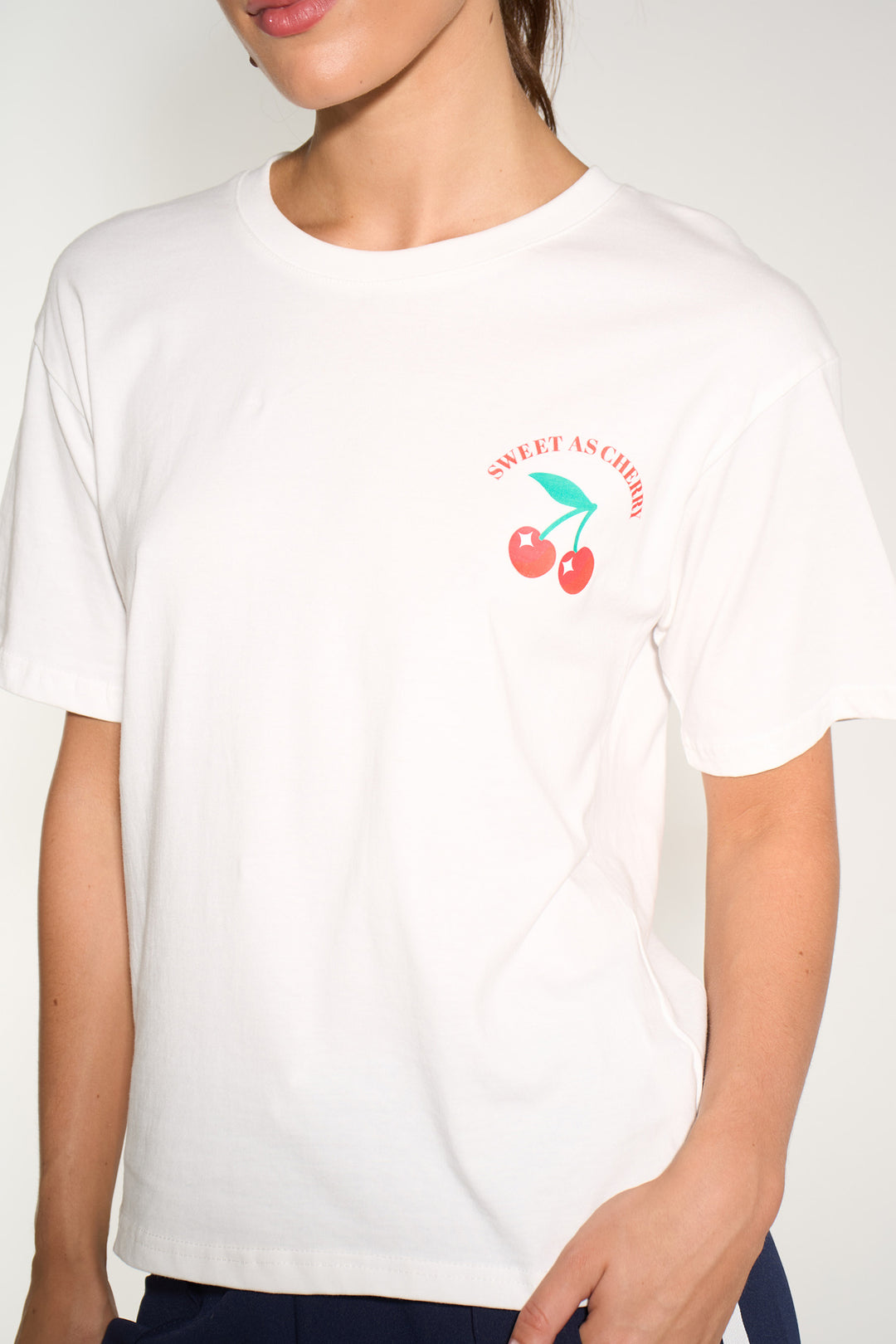 sweet-cherries-short-sleeve-cotton-t-shirt-in-white-closeup-logo-front
