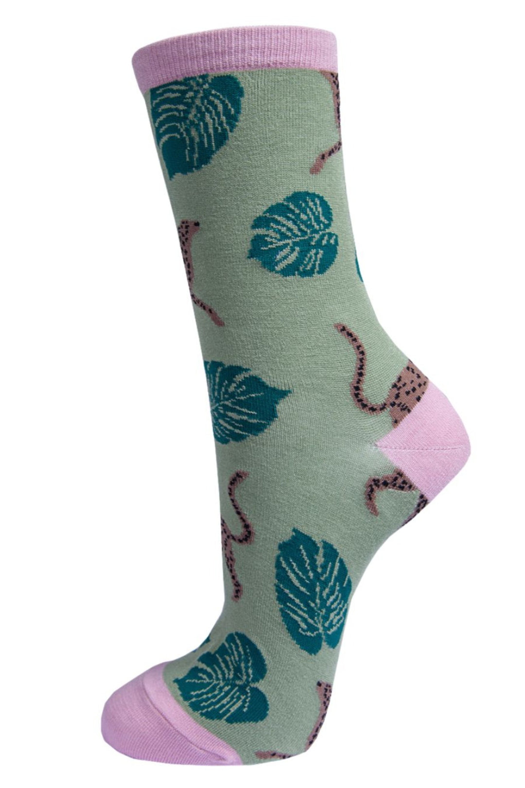 green socks with a pattern of cheetah cats and large green jungle leaves