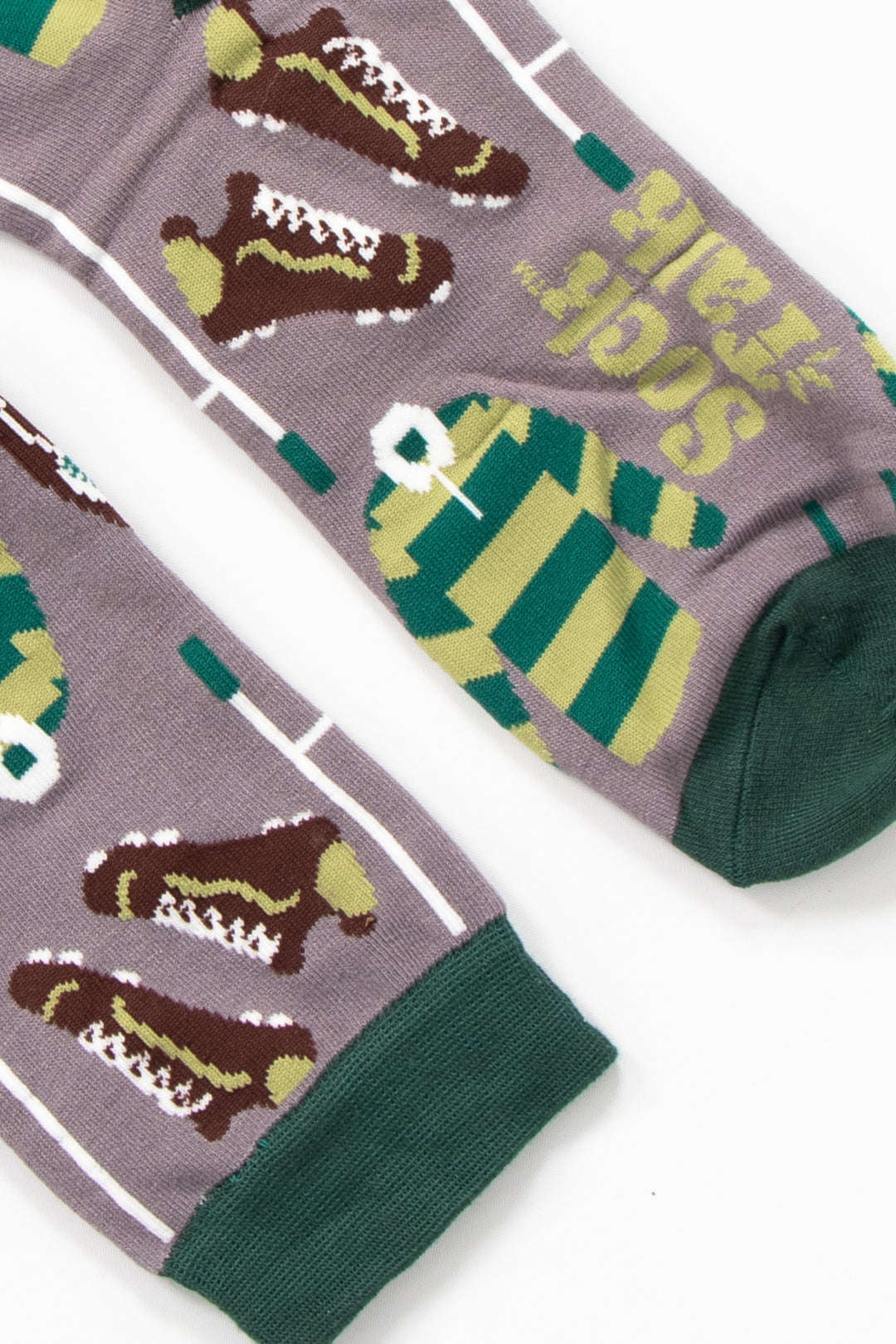close up of the cuff and toe on the rugby bamboo socks. the toe and cuff are dark green and contrast the grey background of the design.