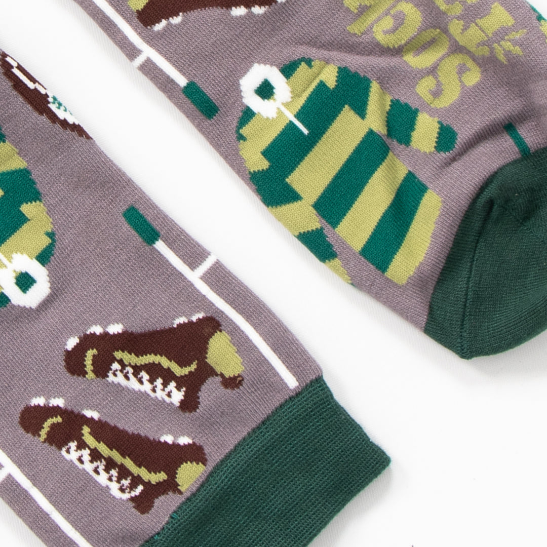 close up of the cuff and toe on the rugby bamboo socks. the toe and cuff are dark green and contrast the grey background of the design.