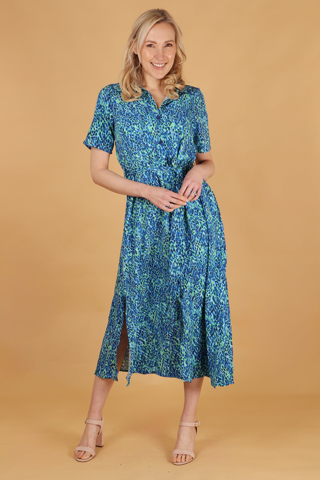 model wearing a blue and green abstract print shirt dress with button down front and waist tie