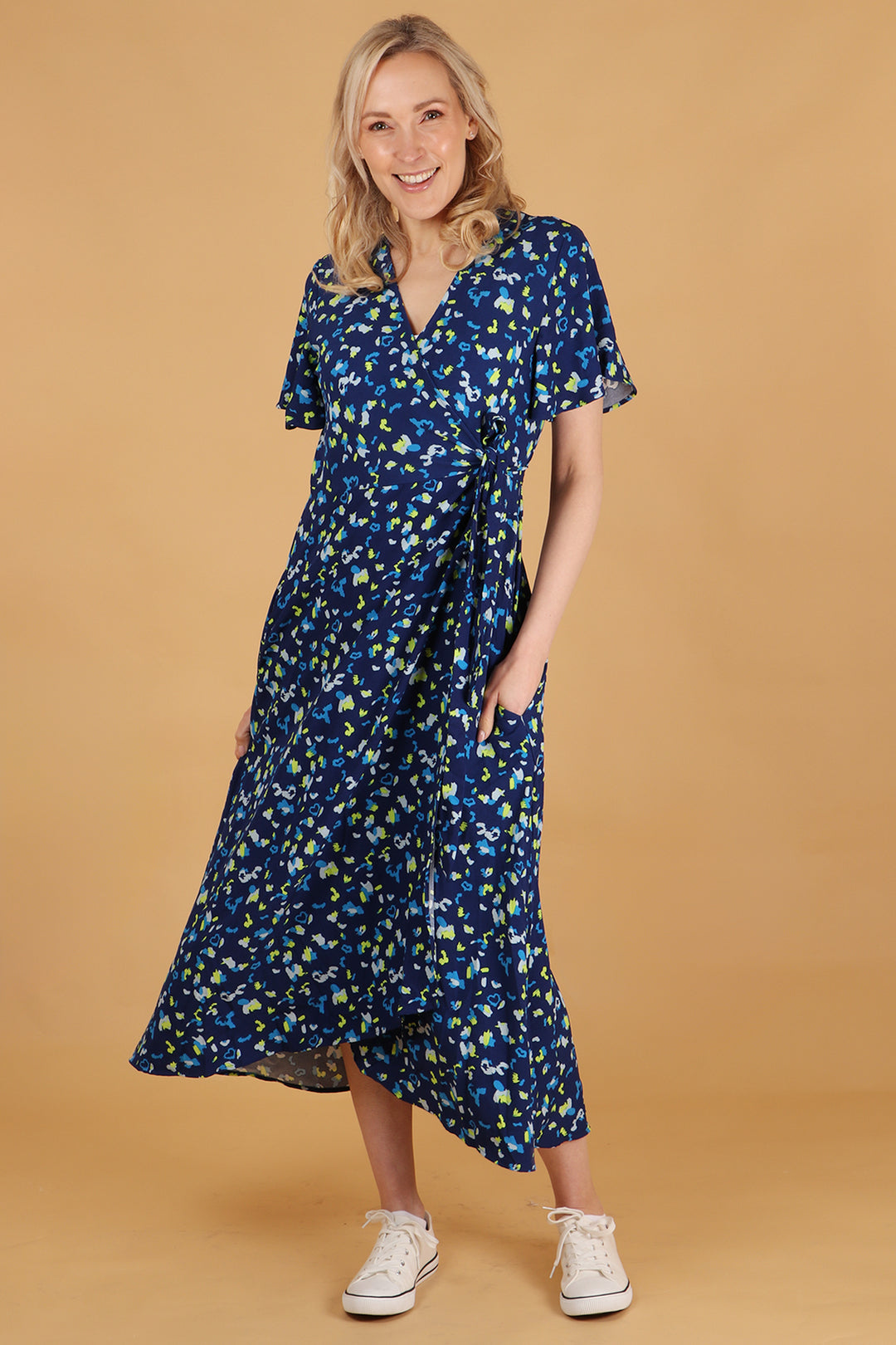 model wearing a blue abstract leopard print short sleeve wrap dress