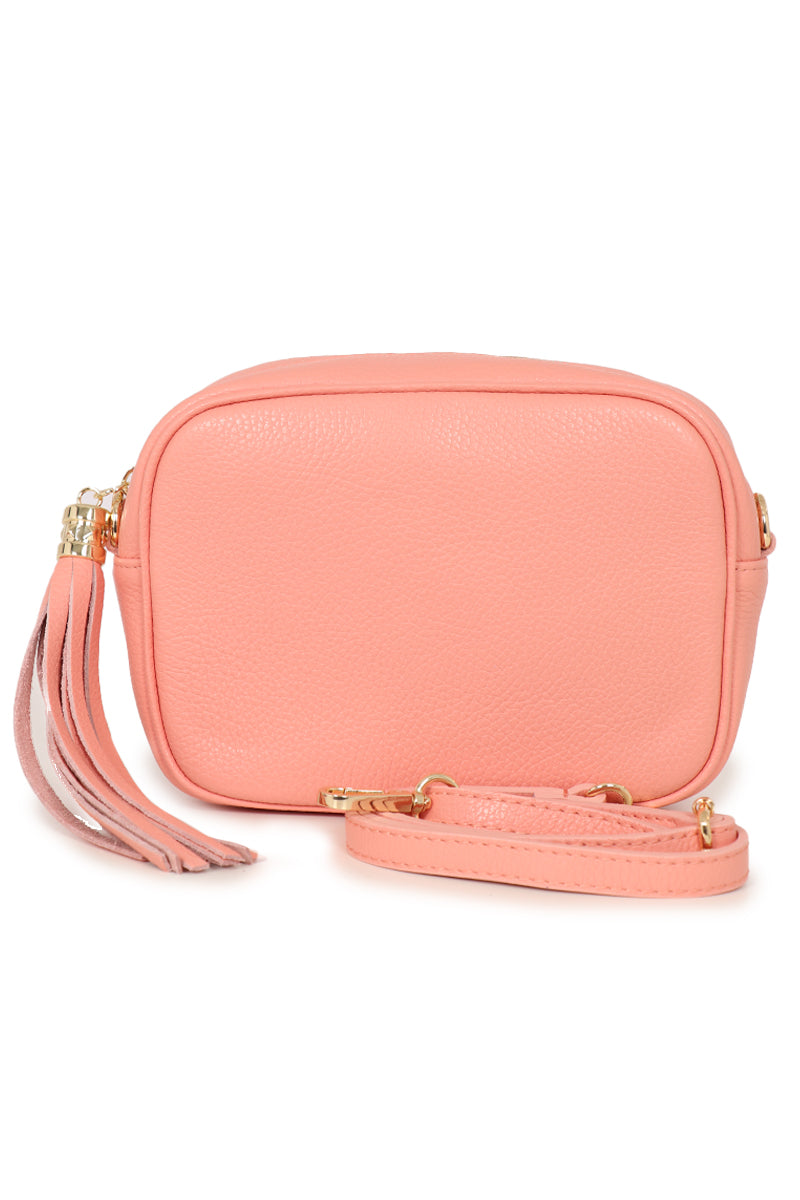 salmon pink leather crossbody camera bag with a detachable adjustable bag strap