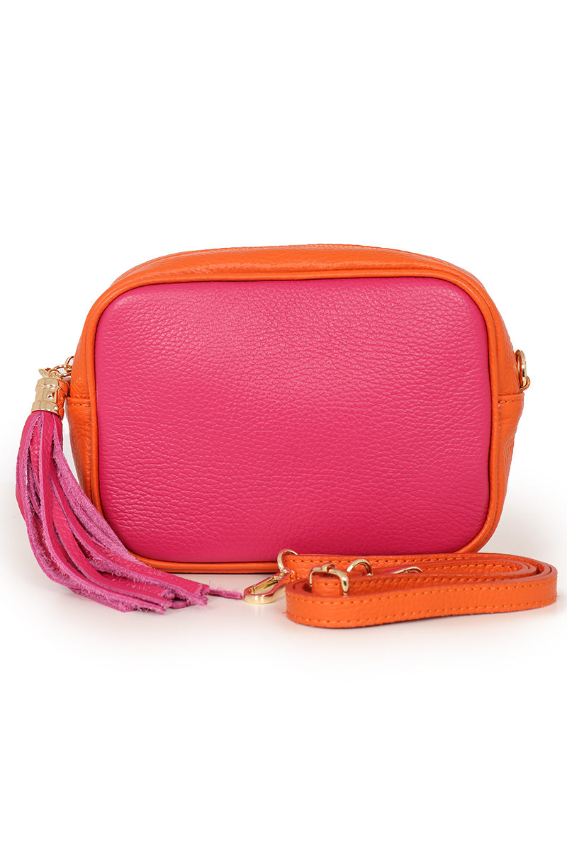 fuchsia pink and orange leather crossbody camera bag with a detachable orange bag strap