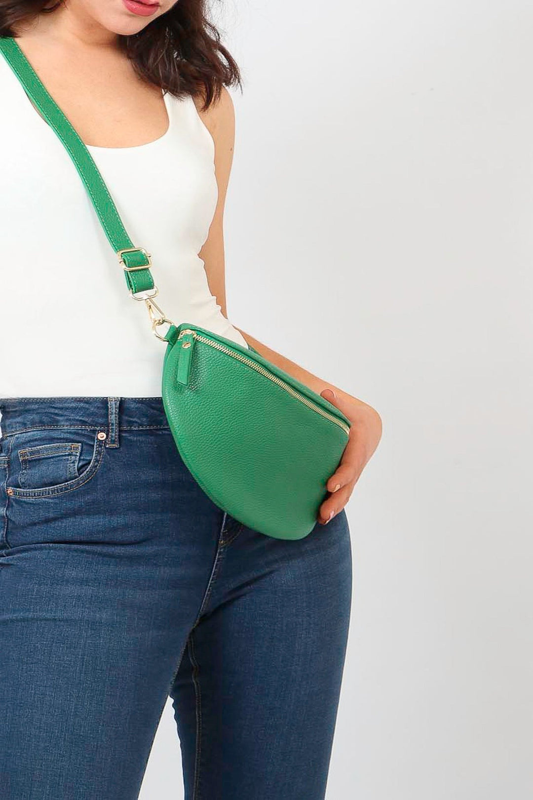 model wearing a large bright green pebbled leather crossbody bag 