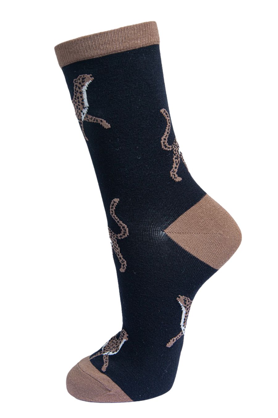 black socks with contrasting brown neutral heel, toe and cuff with an all over pattern of large cheetah cats