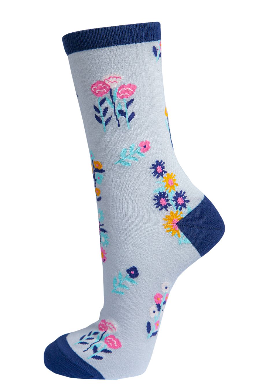 light grey socks with a multicoloured ditsy floral pattern and navy blue heel, toe and cuff