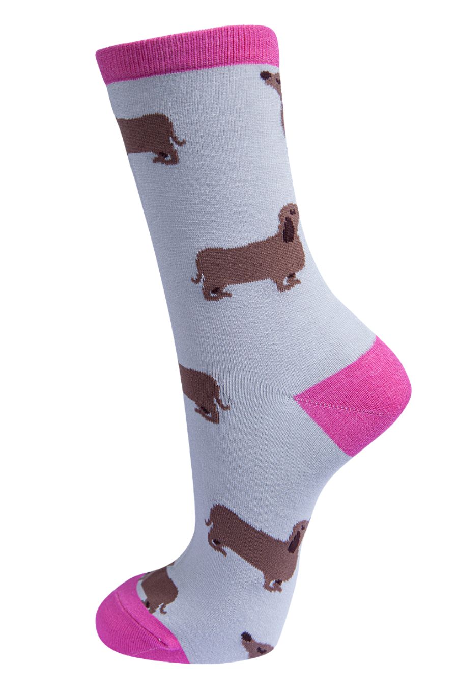 light grey socks with hot pink heel, toe and cuff with a pattern of beige sausage dogs all over