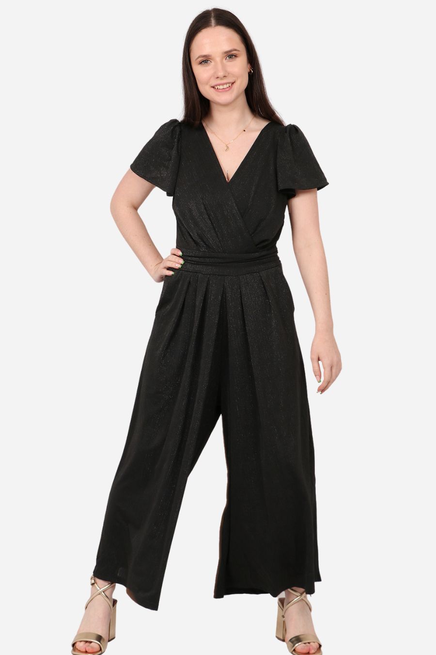 Model wearing black glitter jumpsuit with v-neck and tie waist